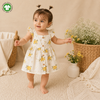 Baby Girl Wearing Organic Cotton Yellow Floral Dress in Natural Lifestyle Setting